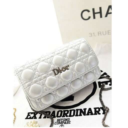 a white purse with a white heart on the front and a white background.