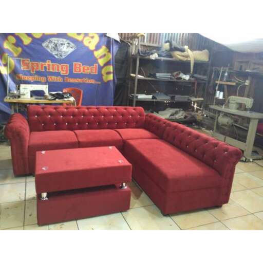 the couch is made from a red leather.