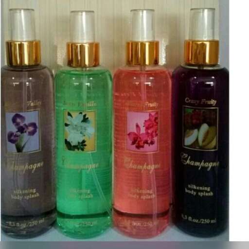 a collection of perfumes in a row on a shelf.