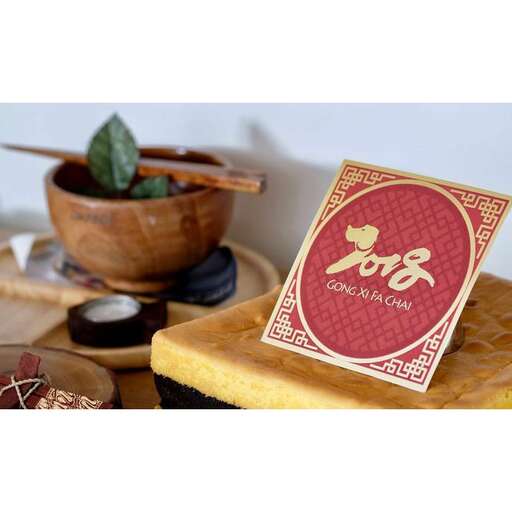 a small wooden box with a red and white coaster.