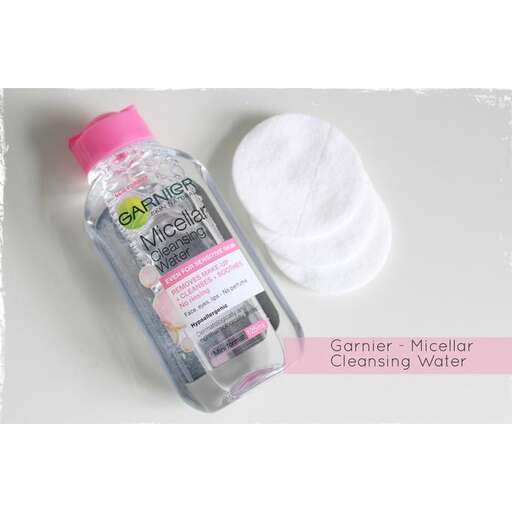 a bottle of water with a pink lid.