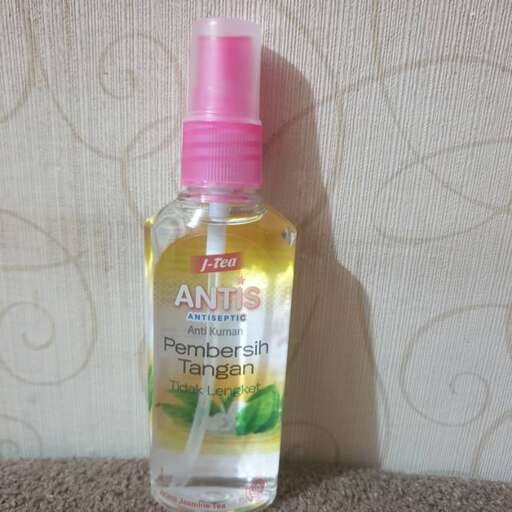 a bottle of perfume with a pink top