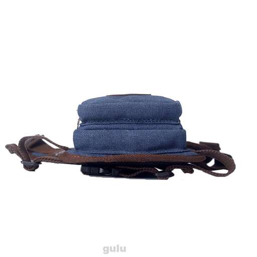 a blue hat is sitting on a brown leather case.