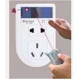 a hand holding a coin to a white light switch.