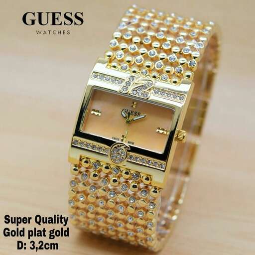 a watch with a gold finish and a diamond.