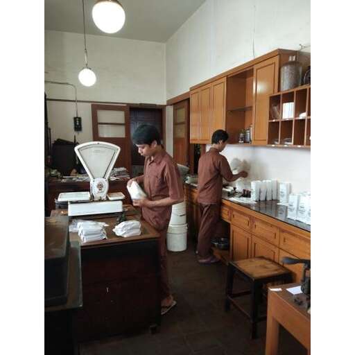 two workers in a kitchen preparing food.