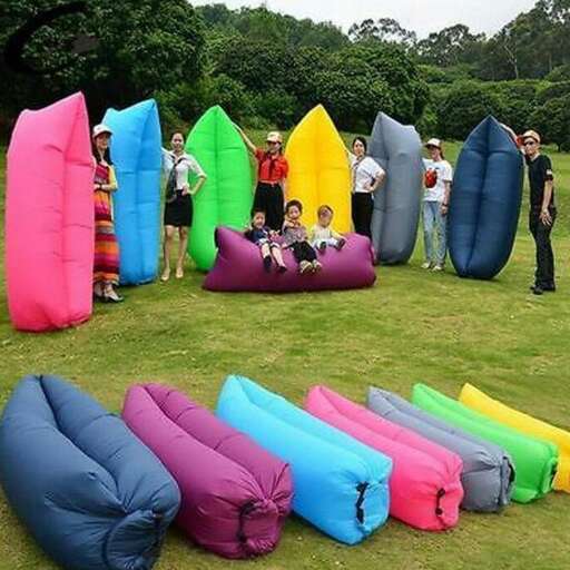 a group of people standing around inflatable boats.