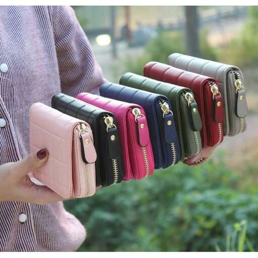 a person holding a bunch of cell phones in their hands.