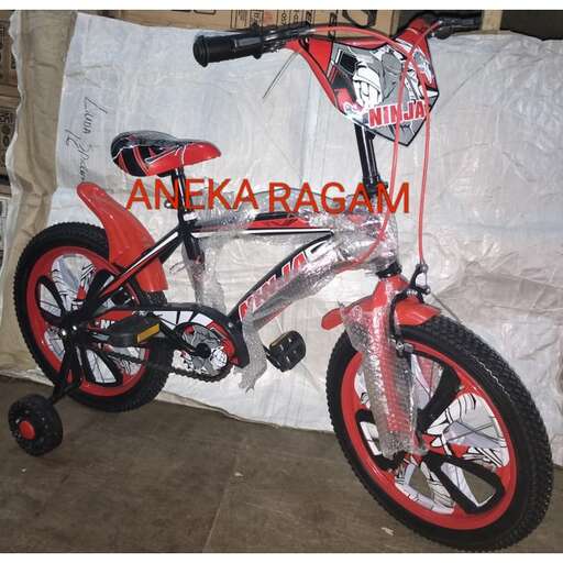 a red bike is on display in a room.