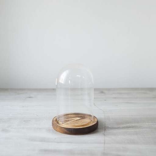 a clear light bulb sitting on a wooden table.