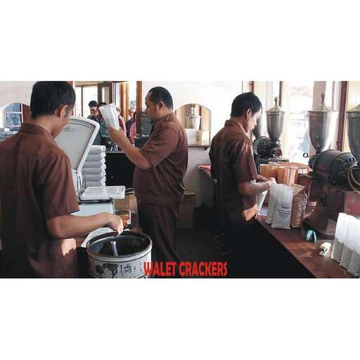 a group of men standing in a kitchen.