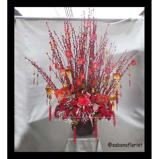 a bouquet of red flowers in a black frame.
