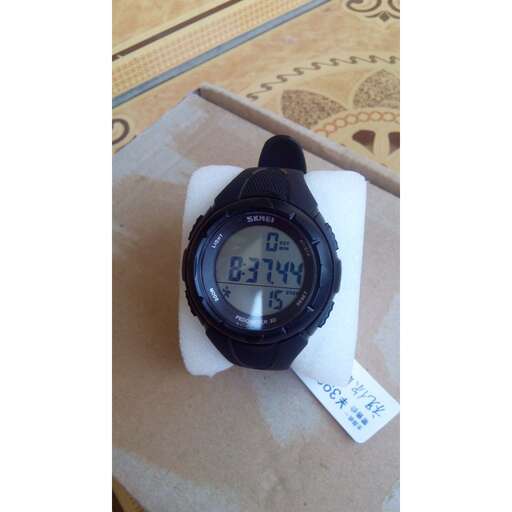a digital clock with a digital display on a paper bag.