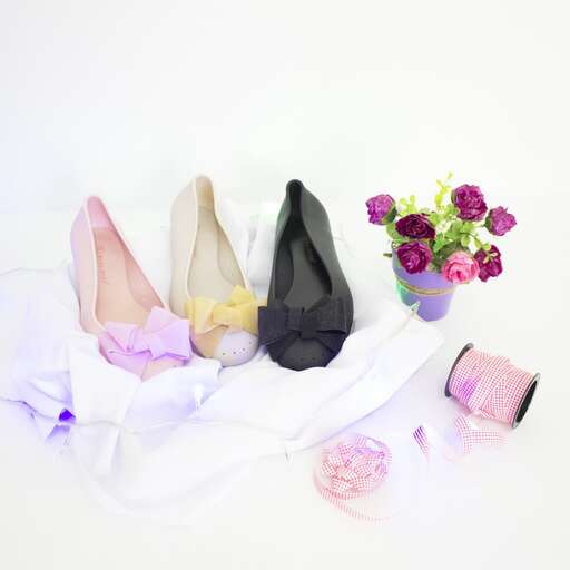 a bunch of different shoes sitting on top of a white surface.