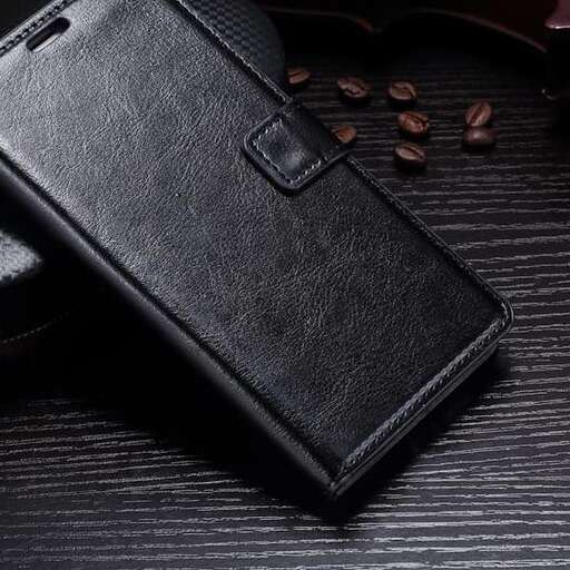 a black leather wallet on a black background.