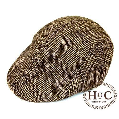 a brown and tan hat is shown on a white background.