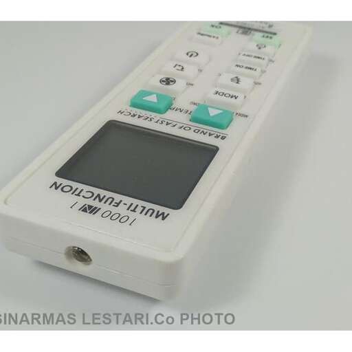 a white electronic device with green buttons.