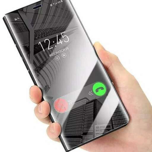 a person holding a smart phone in their hand.