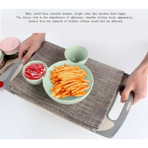 a person is cutting up french fries on a tray.