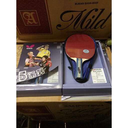 a table with a tennis racket and some magazines.