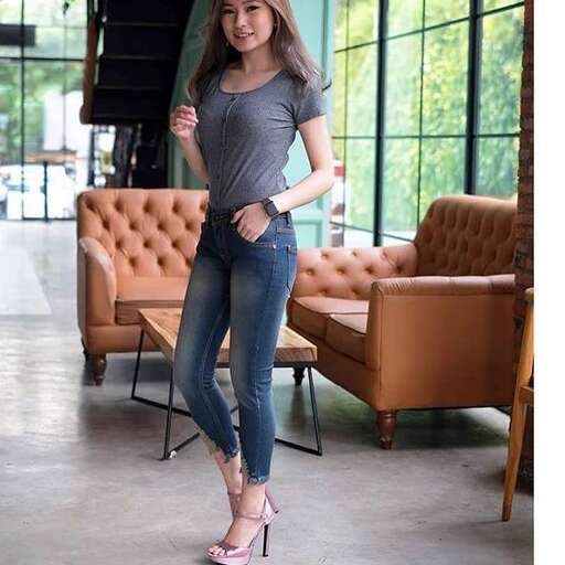 a woman standing in a room holding an umbrella.