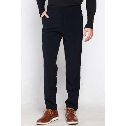 a man in a black shirt and brown shoes