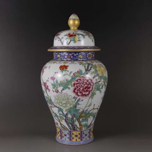 a vase with a floral pattern and a bird on top.