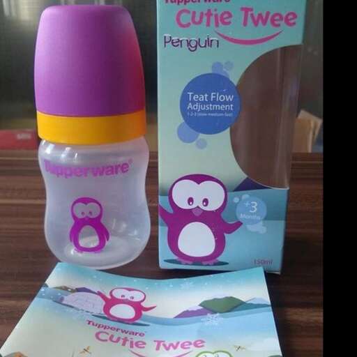 a bottle of baby shower with a penguin on it.