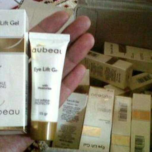 a hand holding a tube of creams.