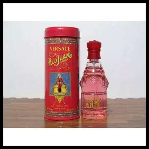 a bottle of perfume with a red lid.