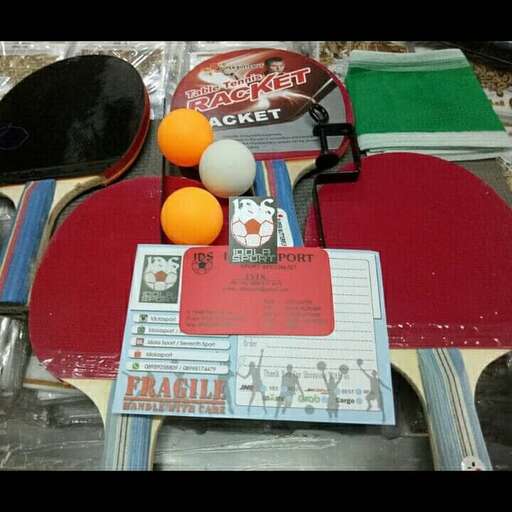 a table with a table set and a table with a tennis racket and a ball.