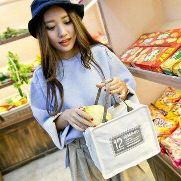 a woman in a blue hat and a bag