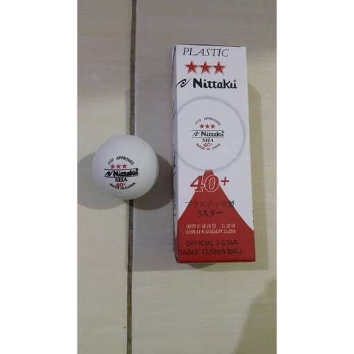 a small white ball and a small bottle of red wine.