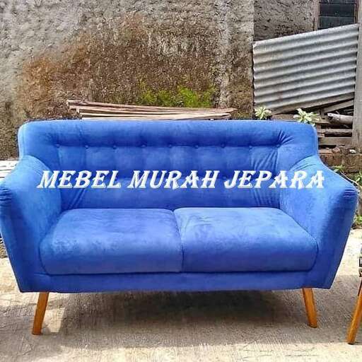 a couch with a chair on the side of it.