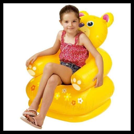 a girl sitting on a yellow inflatable toy.