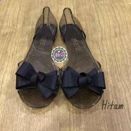 a pair of sandals with a bow