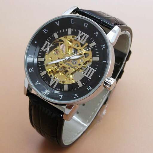 a watch with a black face and gold dial.