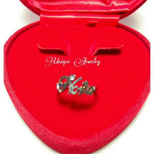 a small red heart shaped box with a silver clasp.