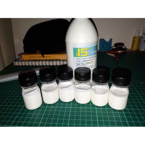 a group of bottles of milk and bottles on a table.