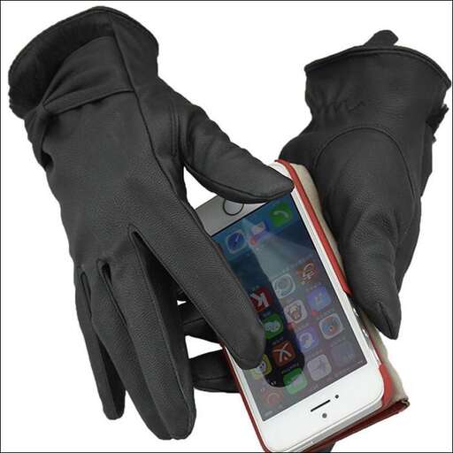 a pair of gloves are being held by a hand.