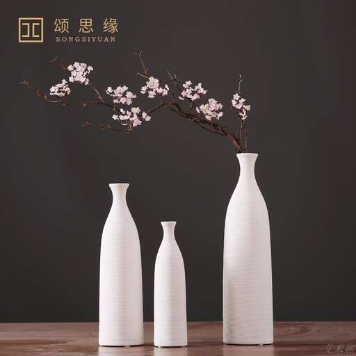 a group of vases with flowers in them.