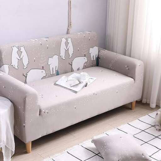 a couch with a white and gray rug and a white floor
