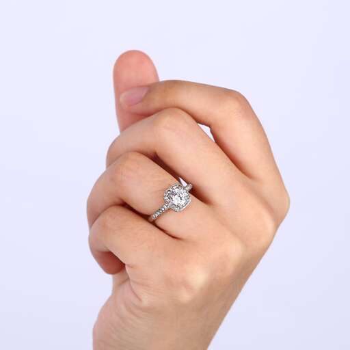 a close up of a hand holding a diamond