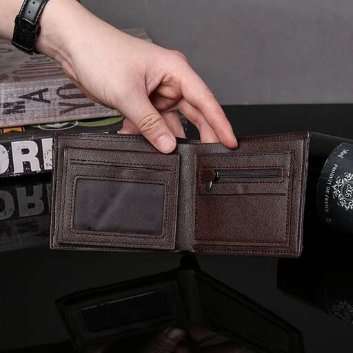 a person holding a wallet with a wallet inside.