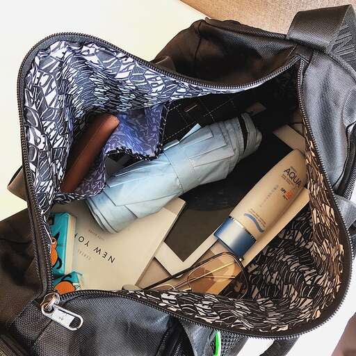 a bag with a lot of items in it.