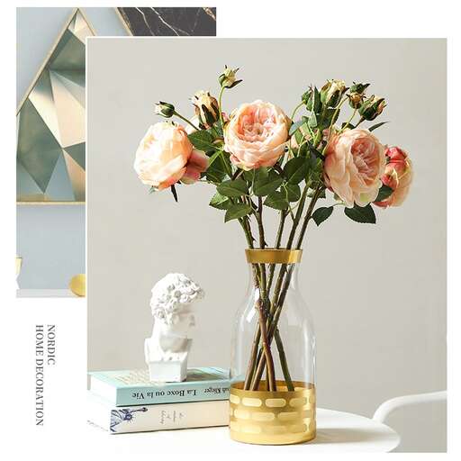 a vase with a vase of flowers on a table.