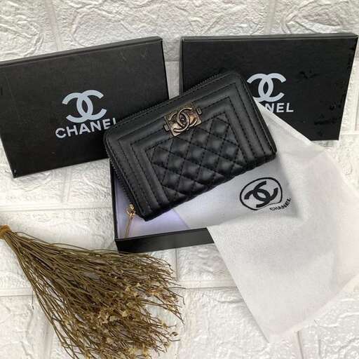 a wallet with a gold leaf and a black wallet.