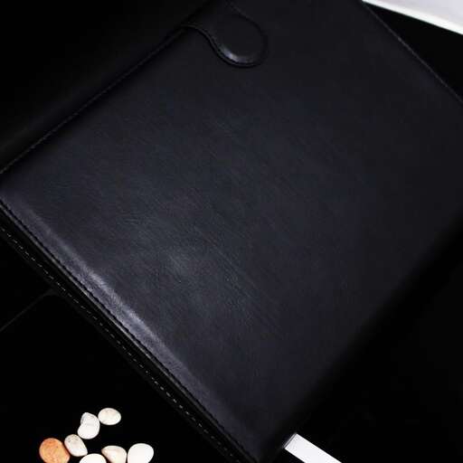 a black leather wallet with a white and orange design.