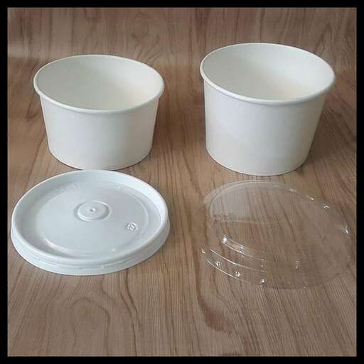 two bowls and a bowl are sitting on a table.