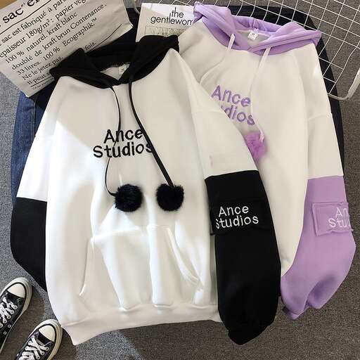 a student's jacket, with a black tie and white shirt.